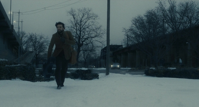Wide shot frame from Inside Llewyn Davis — walking, street, coat