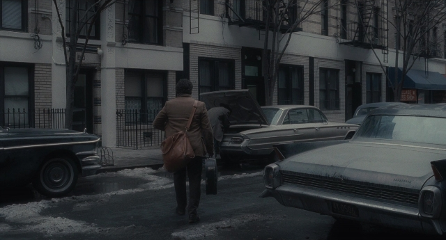 Wide shot frame from Inside Llewyn Davis — walking, street, car
