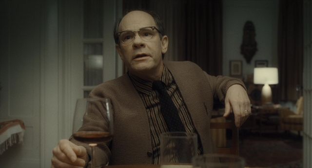 Medium shot frame from Inside Llewyn Davis — sitting, room, table