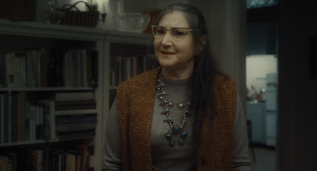 Wide shot frame from Inside Llewyn Davis — book, standing, room