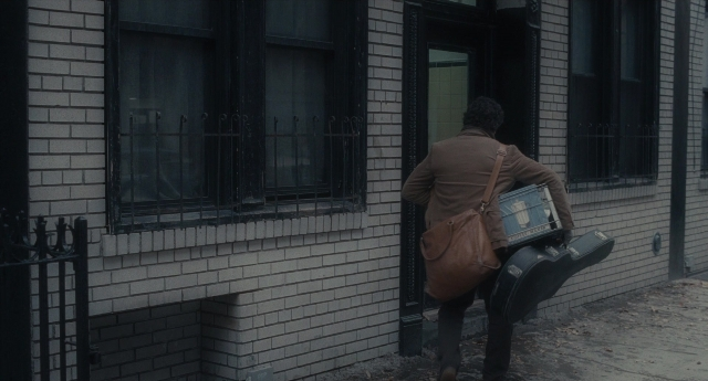 Wide shot frame from Inside Llewyn Davis — walking, street, coat