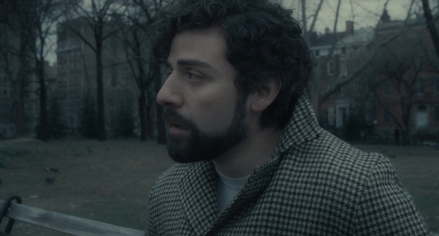 Medium shot frame from Inside Llewyn Davis — sitting, coat, shirt