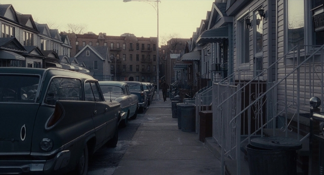 Wide shot frame from Inside Llewyn Davis — street, car, house
