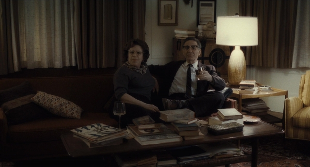 Wide shot frame from Inside Llewyn Davis — sitting, book, table