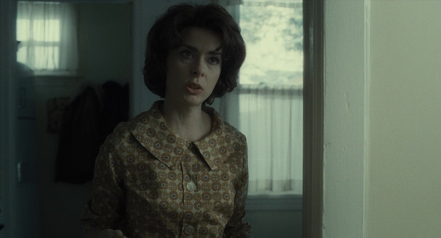 Wide shot frame from Inside Llewyn Davis — standing, room, shirt