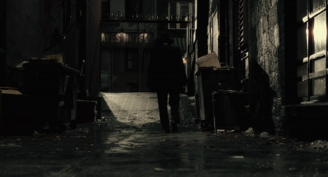 Wide shot frame from Inside Llewyn Davis — walking, street, hat