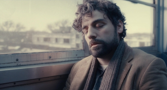 Medium shot frame from Inside Llewyn Davis — sitting, beard, hair