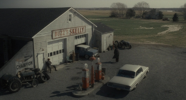 Wide shot frame from Inside Llewyn Davis — standing, car, house