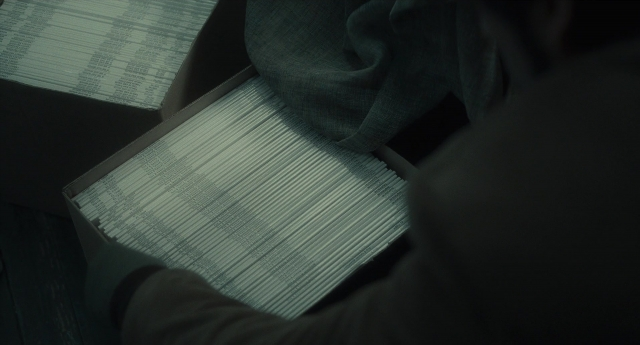 Wide shot frame from Inside Llewyn Davis — sitting, hand, person