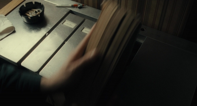 Frame from Inside Llewyn Davis — table, hand, face