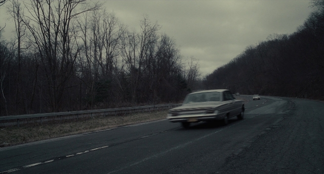 Wide shot frame from Inside Llewyn Davis — street, car, wheel