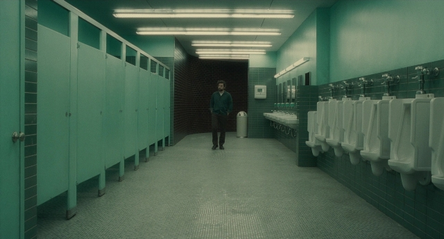 Wide shot frame from Inside Llewyn Davis — standing, shirt, glass