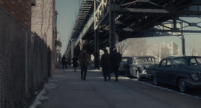 Wide shot frame from Inside Llewyn Davis — walking, street, car