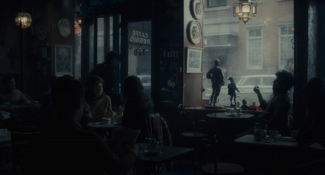 Wide shot frame from Inside Llewyn Davis — sitting, standing, room