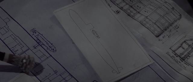 Wide shot frame from The Hunt for Red October — table, hand, person