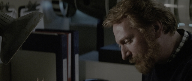 Wide shot frame from The Hunt for Red October — hand, shirt, beard
