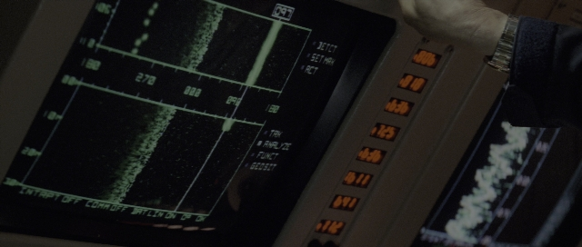 Wide shot frame from The Hunt for Red October — hand, clock, person
