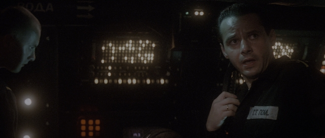 Wide shot frame from The Hunt for Red October — room, dialogue, gun