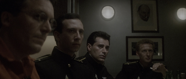 Wide shot frame from The Hunt for Red October — sitting, room, table