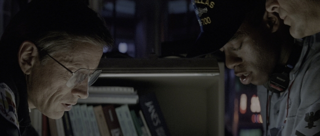 Wide shot frame from The Hunt for Red October — room, dialogue, hat
