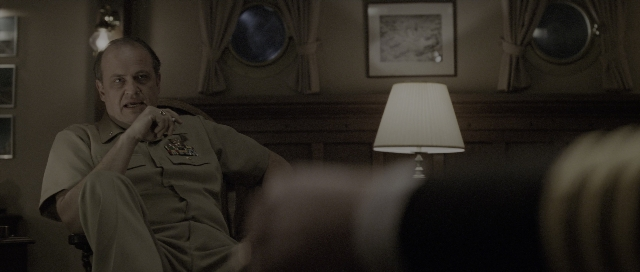 Wide shot frame from The Hunt for Red October — sitting, room, uniform