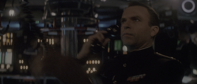 Wide shot frame from The Hunt for Red October — room, hand, suit