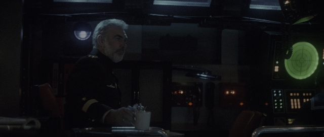Wide shot frame from The Hunt for Red October — sitting, room, uniform