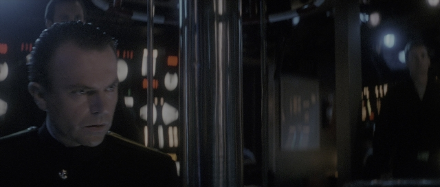 Wide shot frame from The Hunt for Red October — room, uniform, face