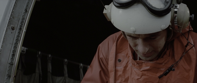 Wide shot frame from The Hunt for Red October — hat, face, person