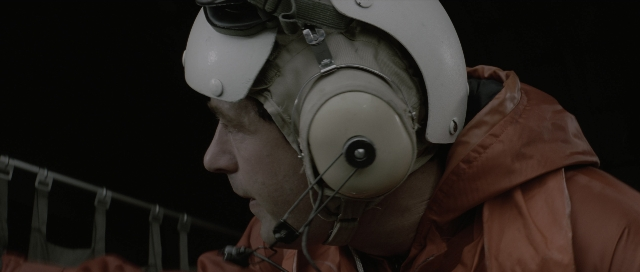 Wide shot frame from The Hunt for Red October — hat, face, person