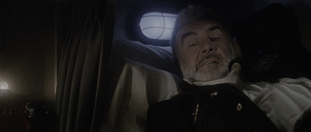 Wide shot frame from The Hunt for Red October — suit, shirt, beard