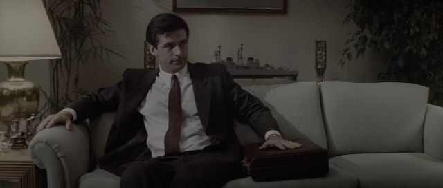 Wide shot frame from The Hunt for Red October — sitting, room, hand