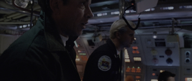 Wide shot frame from The Hunt for Red October — standing, room, face