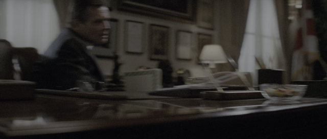 Wide shot frame from The Hunt for Red October — sitting, room, table