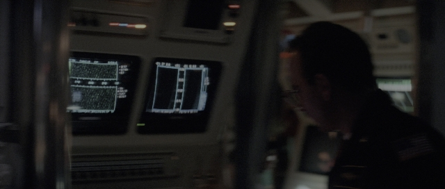 Wide shot frame from The Hunt for Red October — sitting, standing, room