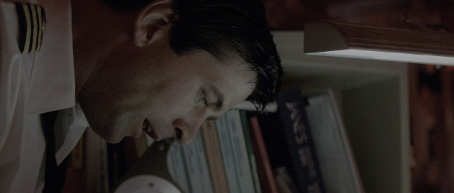 Wide shot frame from The Hunt for Red October — room, shirt, face