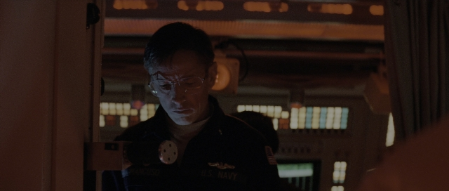 Wide shot frame from The Hunt for Red October — standing, room, door