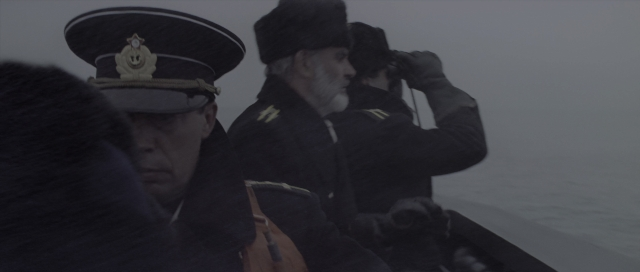Wide shot frame from The Hunt for Red October — standing, hat, hand