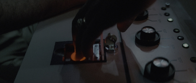 Wide shot frame from The Hunt for Red October — hand, person, home appliance