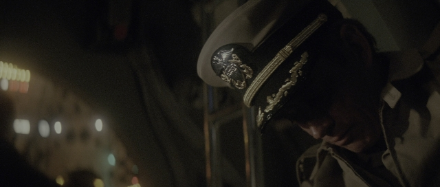 Wide shot frame from The Hunt for Red October — phone, hat, uniform