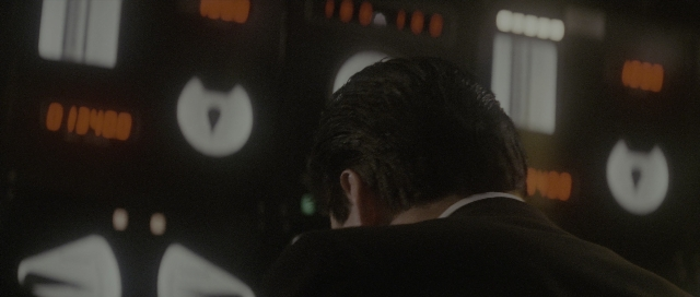 Wide shot frame from The Hunt for Red October — standing, suit, face