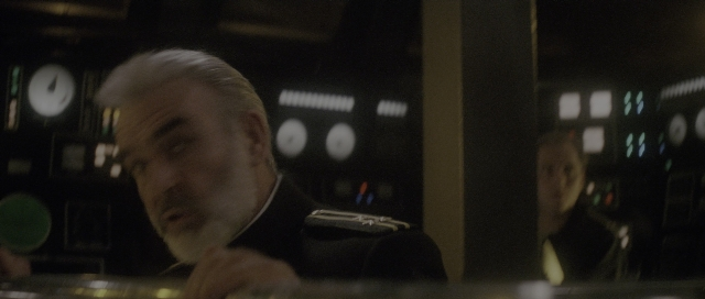 Wide shot frame from The Hunt for Red October — sitting, room, uniform