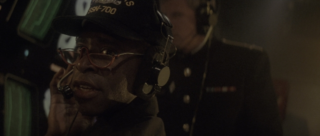 Wide shot frame from The Hunt for Red October — room, dialogue, hat