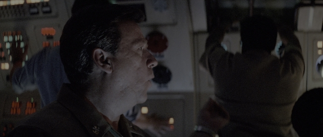 Wide shot frame from The Hunt for Red October — standing, uniform, hair