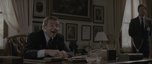 Wide shot frame from The Hunt for Red October — sitting, standing, table