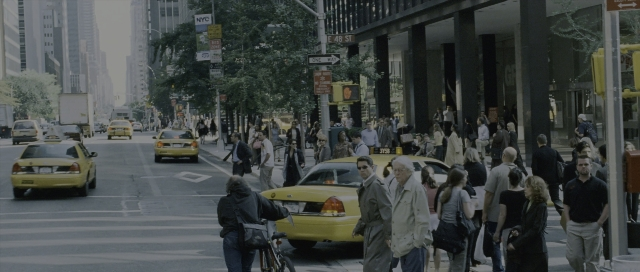 Wide shot frame from The Bourne Supremacy — walking, street, wheel