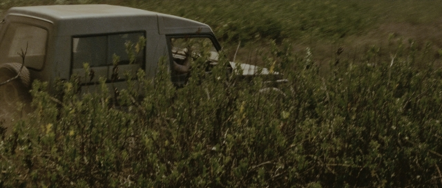 Wide shot frame from The Bourne Supremacy — car, hand, person