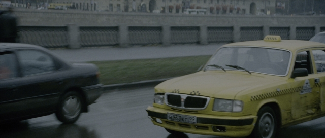 Wide shot frame from The Bourne Supremacy — street, car, wheel