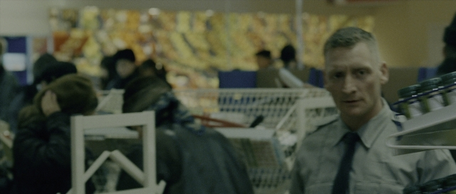 Wide shot frame from The Bourne Supremacy — standing, tie, food