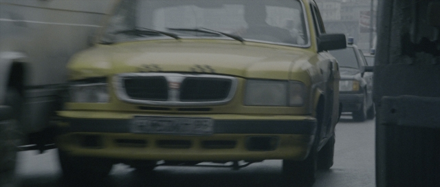 Wide shot frame from The Bourne Supremacy — street, car, wheel